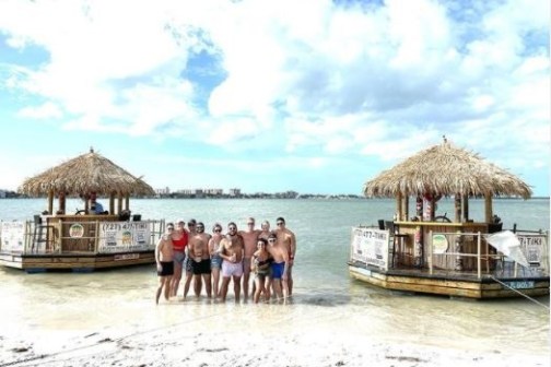 a group of people standing next to a body of water